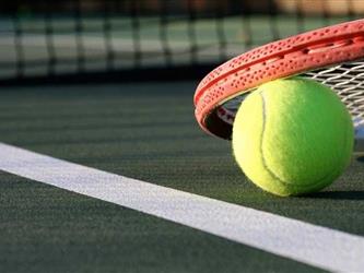 tennis ball and racquet on court