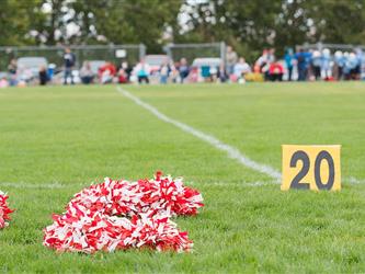 red and white pom pom on field